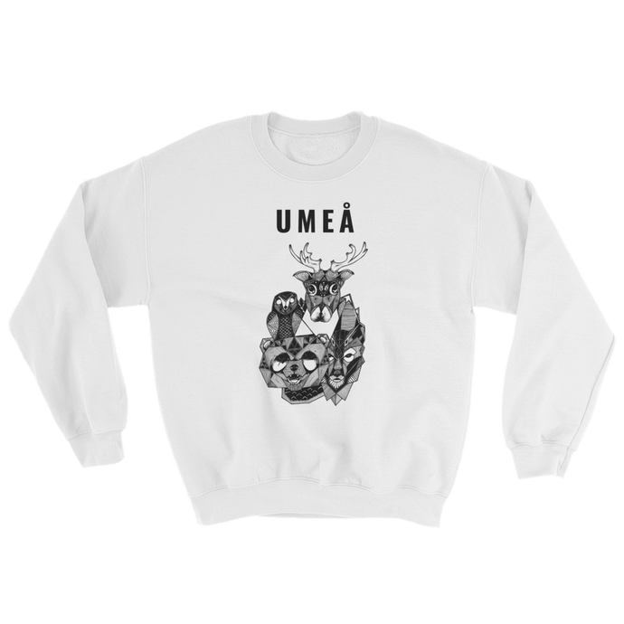 White sweater with the Umeå design of a reindeer, an owl, a bear and a wolf gathered around Nydala lake. Original artwork by Jonn Designs.