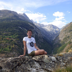 Model wearing a white t-shirt with the Umeå design in the Alps